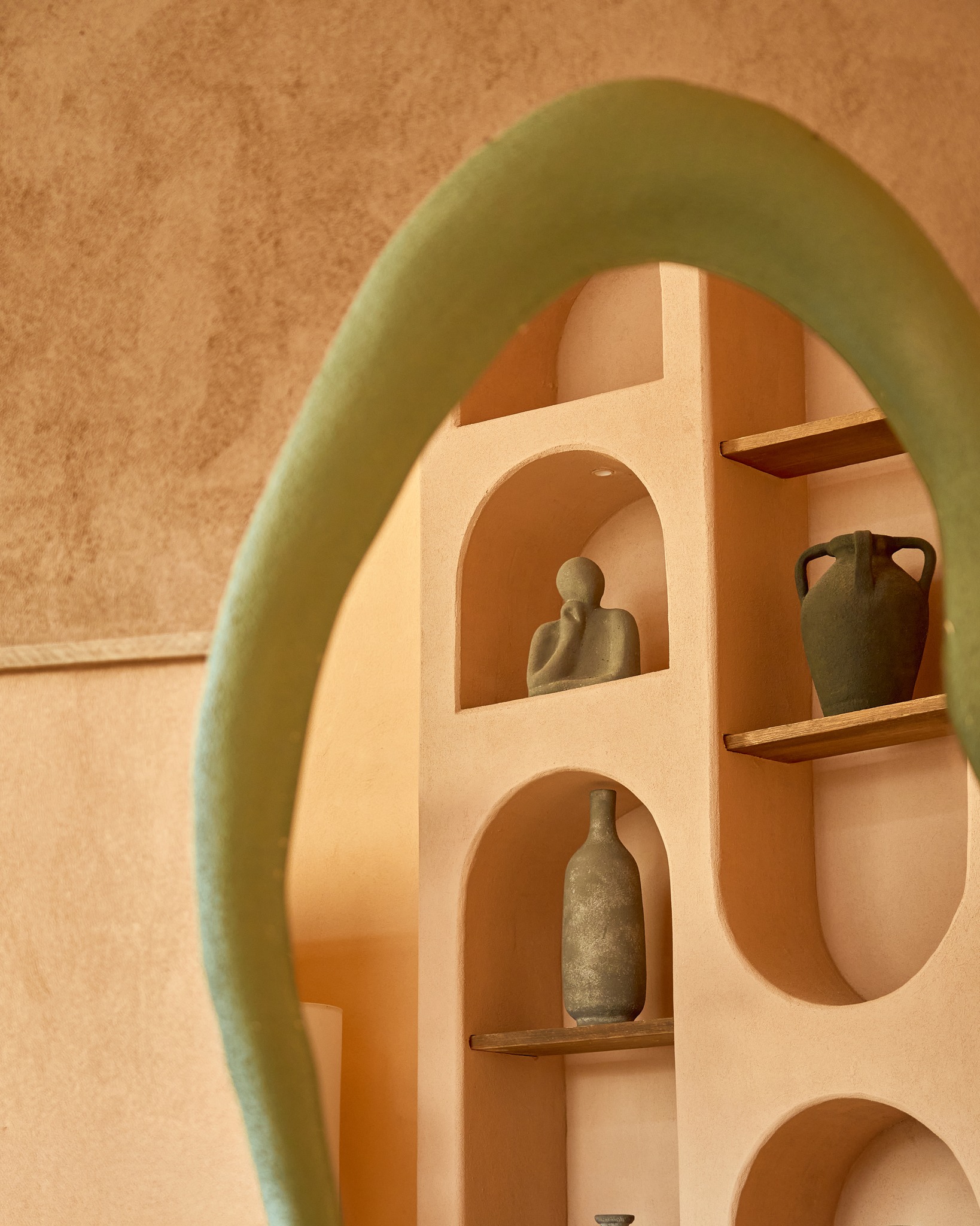 Terracotta niche shelving with ceramic vessels