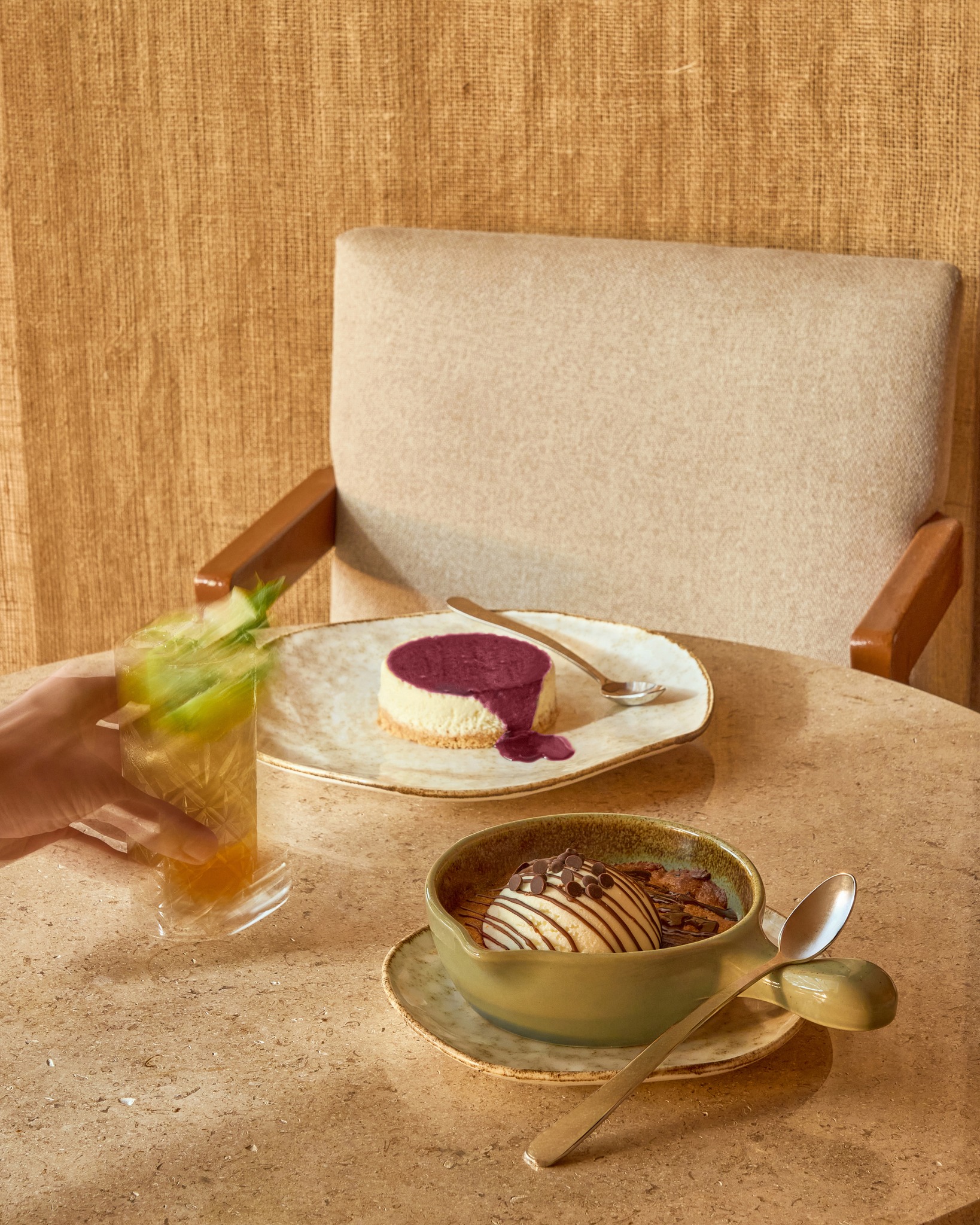 Cheesecake and a warm cookie dessert on a travertine table