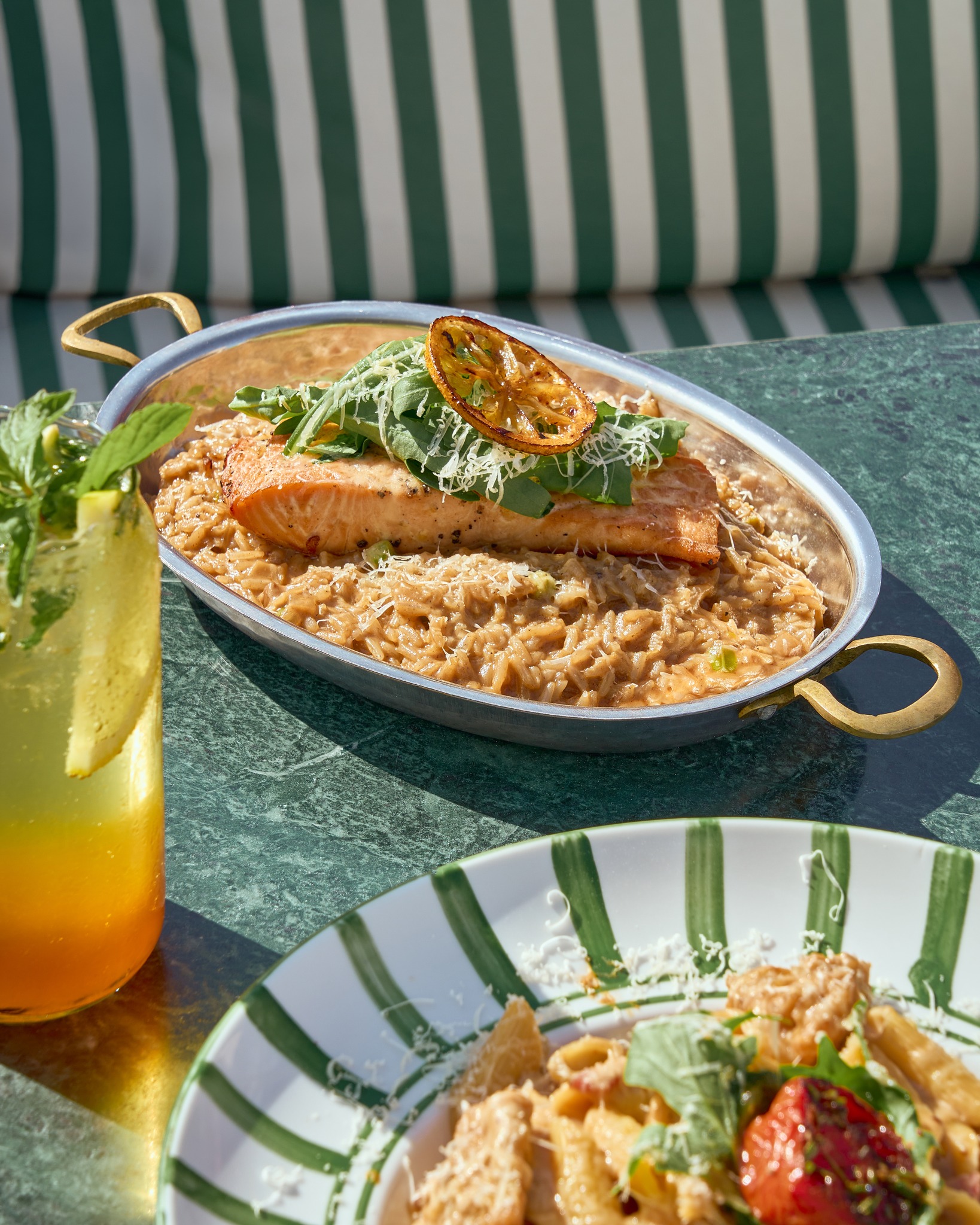 Grilled salmon on risotto with an iced drink